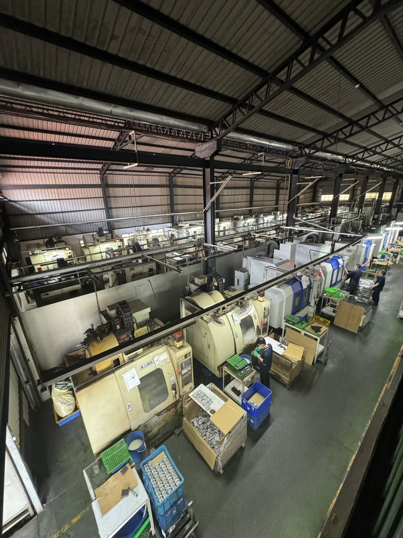 CNC machining floor seen from above, rows of machines in production