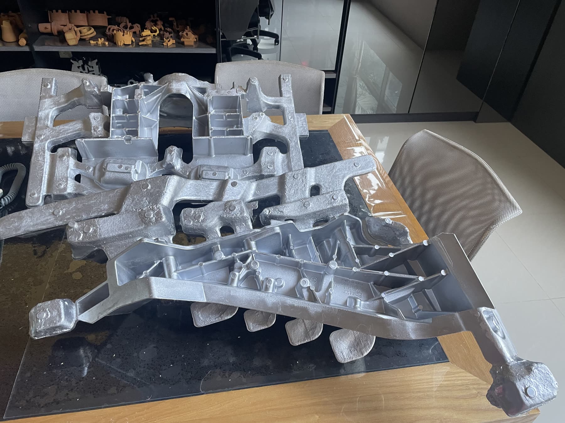 Raw aluminum castings laid out after a production run